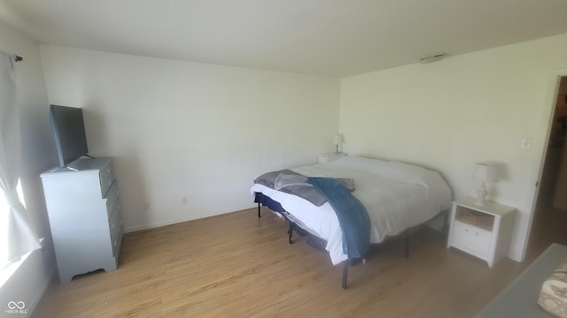 713 Driftwood Cir, Danville, IN 46122 - bedroom featuring light wood-type flooring, a fireplace, and baseboards