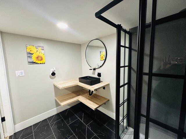 38 Hendricks Pl, Indianapolis, IN 46201 - bathroom with baseboards and marble look tile flooring