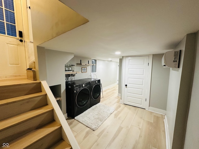 38 Hendricks Pl, Indianapolis, IN 46201 - washroom with washing machine and clothes dryer, light wood-style flooring, a wall mounted air conditioner, and recessed lighting