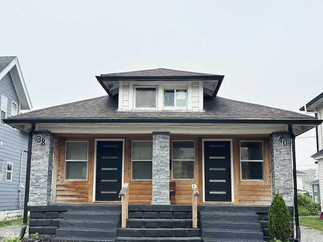 38 Hendricks Pl, Indianapolis, IN 46201 - view of front facade with covered porch and roof with shingles
