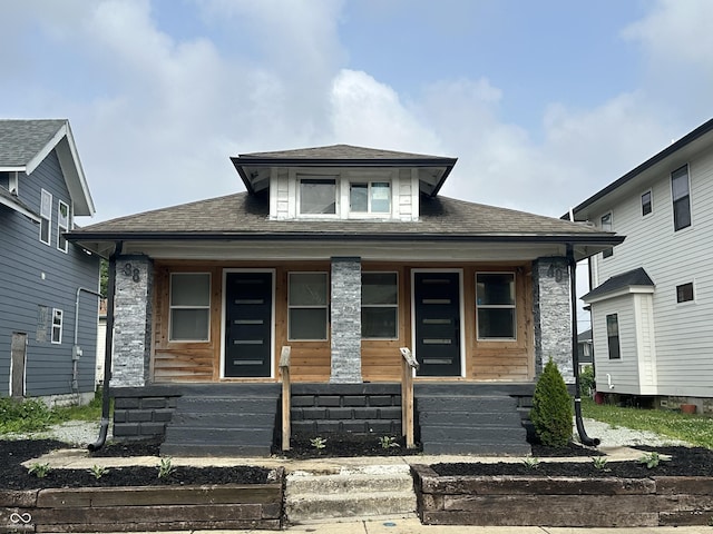 38 Hendricks Pl, Indianapolis, IN 46201 - view of front of house featuring a porch and roof with shingles