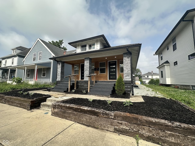 38 Hendricks Pl, Indianapolis, IN 46201 - view of front of home featuring covered porch and stone siding