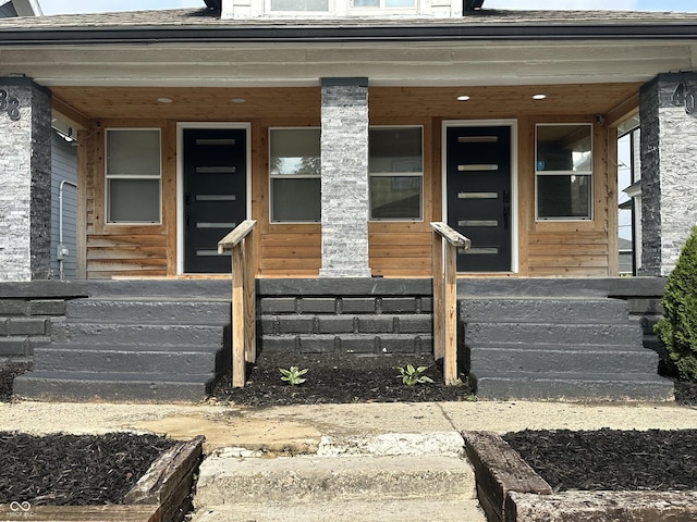 38 Hendricks Pl, Indianapolis, IN 46201 - doorway to property with covered porch and a shingled roof