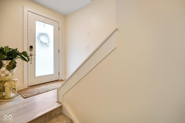 2125 Coretta Way, Indianapolis, IN 46202 - entryway featuring stairway, healthy amount of natural light, baseboards, and wood finished floors