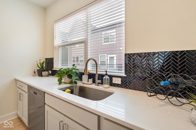 2125 Coretta Way, Indianapolis, IN 46202 - kitchen with a sink, stainless steel dishwasher, light countertops, backsplash, and white cabinetry