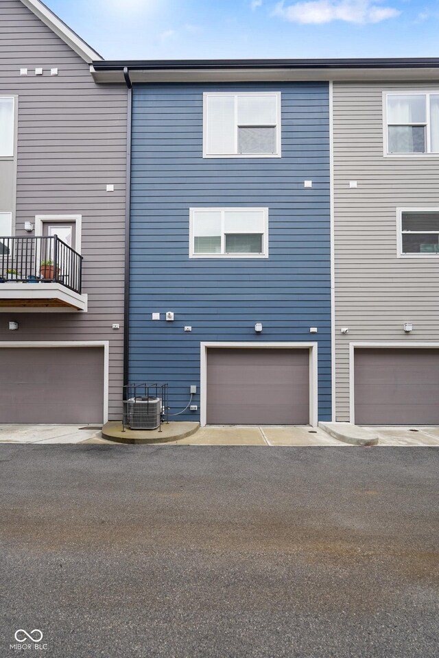 2125 Coretta Way, Indianapolis, IN 46202 - rear view of property with cooling unit and a garage
