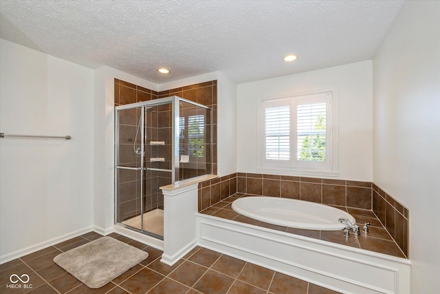 12772 Tram Ln, Carmel, IN 46032 - full bathroom featuring a bath, a shower stall, tile patterned flooring, a textured ceiling, and recessed lighting
