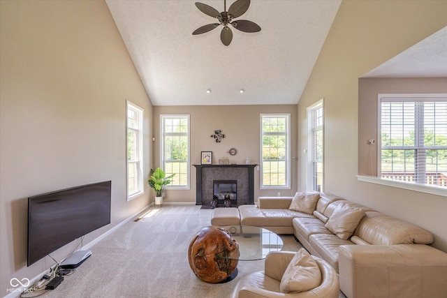 12772 Tram Ln, Carmel, IN 46032 - carpeted living area featuring vaulted ceiling, a tiled fireplace, plenty of natural light, and a ceiling fan