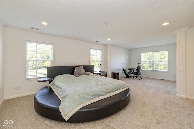 12772 Tram Ln, Carmel, IN 46032 - bedroom with light colored carpet, recessed lighting, and ornate columns