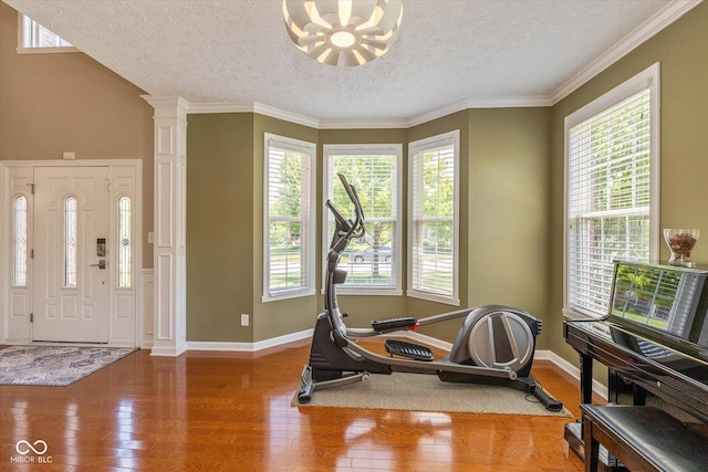 12772 Tram Ln, Carmel, IN 46032 - workout area with hardwood / wood-style floors, a textured ceiling, crown molding, and a chandelier