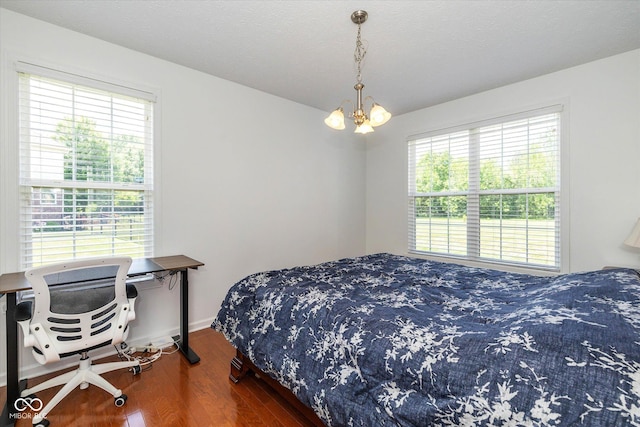 12772 Tram Ln, Carmel, IN 46032 - bedroom featuring a chandelier and wood finished floors