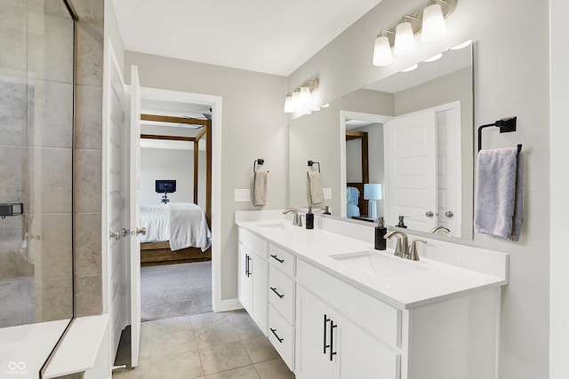 9716 Cimmaron Ave, Mccordsville, IN 46055 - ensuite bathroom featuring double vanity, tile patterned floors, a tile shower, and baseboards