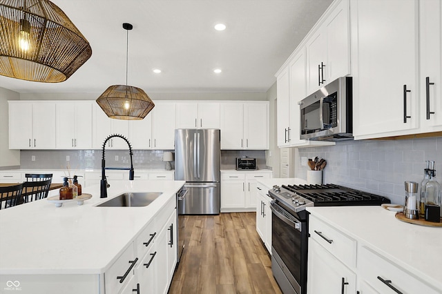 9716 Cimmaron Ave, Mccordsville, IN 46055 - kitchen featuring appliances with stainless steel finishes, a sink, light countertops, tasteful backsplash, and recessed lighting