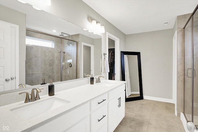 9716 Cimmaron Ave, Mccordsville, IN 46055 - bathroom with a stall shower, double vanity, a spacious closet, baseboards, and tile patterned floors