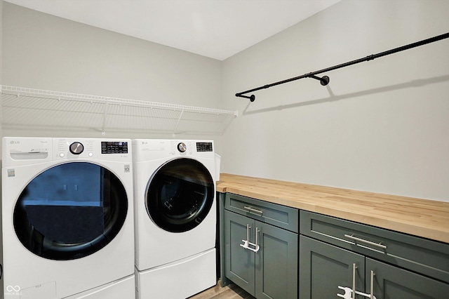 9716 Cimmaron Ave, Mccordsville, IN 46055 - laundry area featuring cabinet space, independent washer and dryer, and light wood-style floors