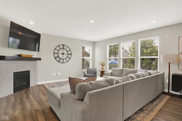 9716 Cimmaron Ave, Mccordsville, IN 46055 - living area featuring dark wood finished floors, baseboards, a tiled fireplace, and recessed lighting