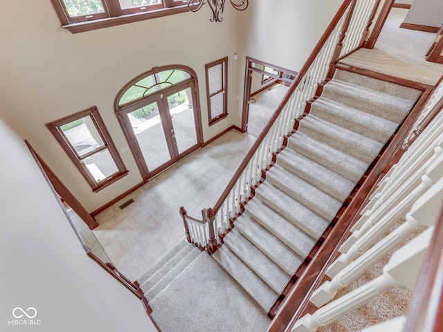20 Forrests Edge Ct, Indianapolis, IN 46227 - stairway with plenty of natural light, baseboards, a high ceiling, a chandelier, and french doors