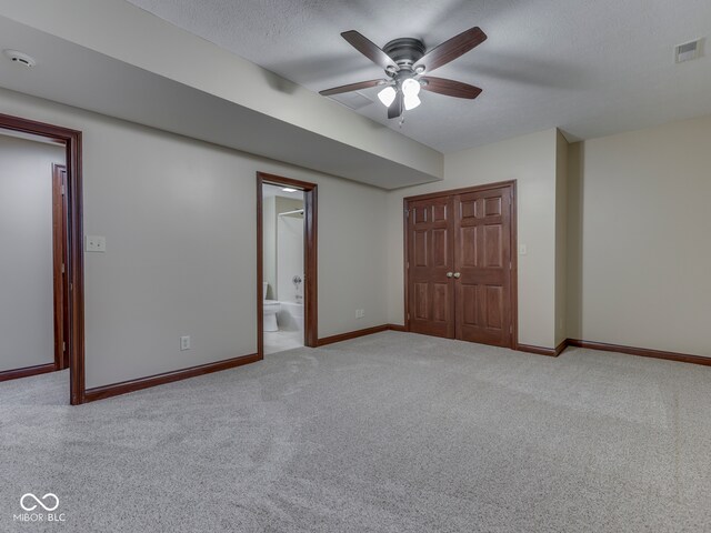 20 Forrests Edge Ct, Indianapolis, IN 46227 - unfurnished bedroom with carpet flooring, a closet, baseboards, connected bathroom, and a textured ceiling
