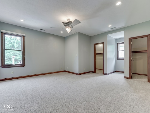 20 Forrests Edge Ct, Indianapolis, IN 46227 - unfurnished bedroom with light colored carpet, recessed lighting, a walk in closet, and baseboards
