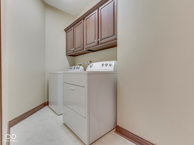 20 Forrests Edge Ct, Indianapolis, IN 46227 - washroom with separate washer and dryer, cabinet space, baseboards, and light tile patterned flooring
