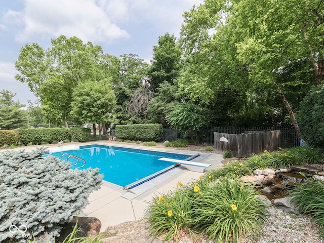 20 Forrests Edge Ct, Indianapolis, IN 46227 - view of pool featuring a diving board, view of scattered trees, and a patio area