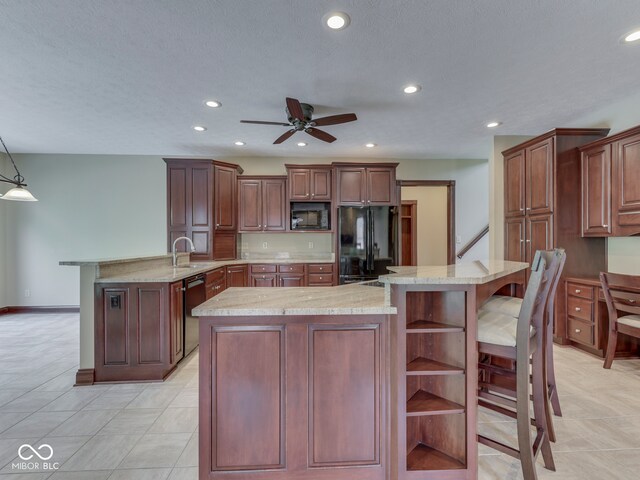 20 Forrests Edge Ct, Indianapolis, IN 46227 - kitchen with black appliances, a breakfast bar area, a peninsula, a kitchen island, and ceiling fan