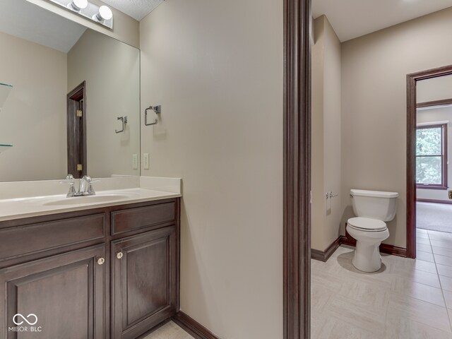 20 Forrests Edge Ct, Indianapolis, IN 46227 - bathroom featuring toilet, vanity, baseboards, and tile patterned flooring
