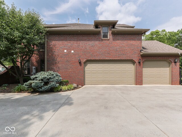 20 Forrests Edge Ct, Indianapolis, IN 46227 - view of front facade featuring concrete driveway, brick siding, a shingled roof, and an attached garage