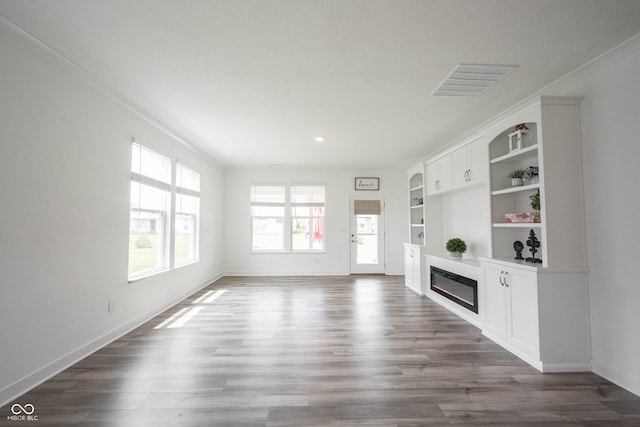 19800 Sutton Ter, Westfield, IN 46074 - unfurnished living room featuring a glass covered fireplace, baseboards, dark wood-style floors, recessed lighting, and built in features