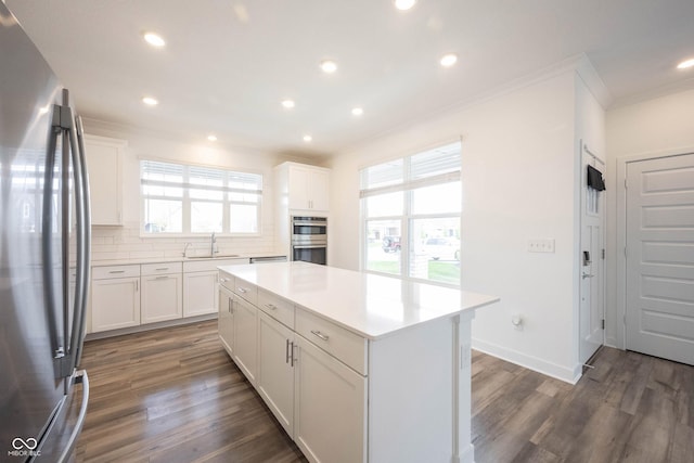 19800 Sutton Ter, Westfield, IN 46074 - kitchen with stainless steel appliances, ornamental molding, decorative backsplash, a sink, and a center island