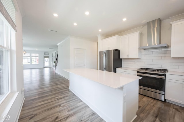 19800 Sutton Ter, Westfield, IN 46074 - kitchen with wall chimney exhaust hood, appliances with stainless steel finishes, a center island, wood finished floors, and decorative backsplash