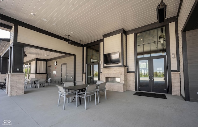 19800 Sutton Ter, Westfield, IN 46074 - view of patio / terrace featuring an outdoor brick fireplace, french doors, and outdoor dining space
