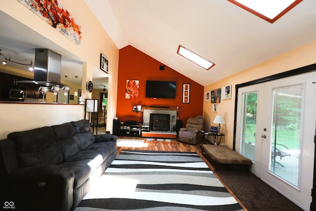 5654 Paradise Dr, Martinsville, IN 46151 - living area with healthy amount of natural light, a fireplace, a skylight, and high vaulted ceiling