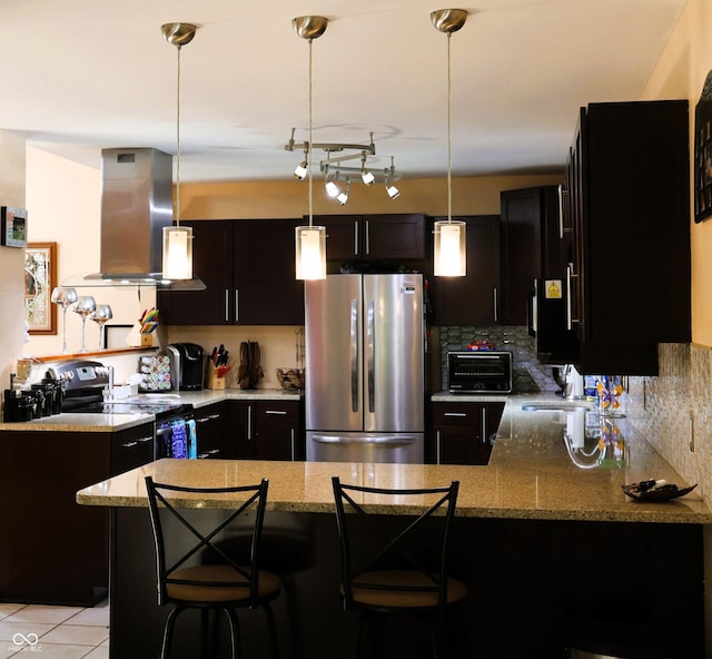 5654 Paradise Dr, Martinsville, IN 46151 - kitchen featuring appliances with stainless steel finishes, island range hood, light stone counters, a peninsula, and decorative light fixtures