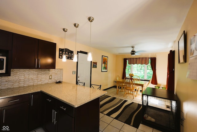 5654 Paradise Dr, Martinsville, IN 46151 - kitchen with tasteful backsplash, a peninsula, light tile patterned flooring, ceiling fan, and decorative light fixtures