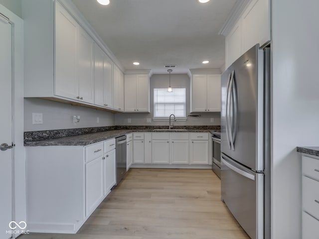 2756 Branigin Creek Blvd, Franklin, IN 46131 - kitchen with stainless steel appliances, a sink, white cabinets, light wood finished floors, and recessed lighting