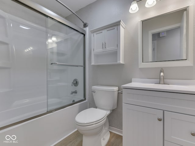 2756 Branigin Creek Blvd, Franklin, IN 46131 - full bathroom featuring wood finished floors, vanity, toilet, bath / shower combo with glass door, and baseboards
