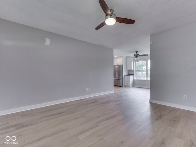 2756 Branigin Creek Blvd, Franklin, IN 46131 - unfurnished living room with ceiling fan, light wood-style floors, and baseboards