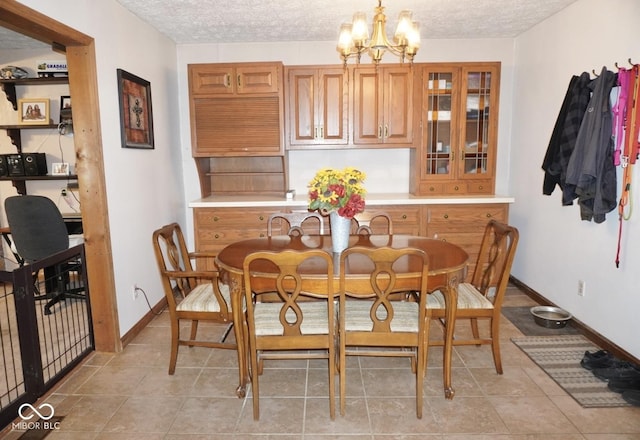 254 Bittersweet Dr, Whiteland, IN 46184 - dining space with a chandelier, a textured ceiling, and baseboards