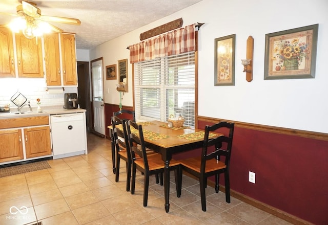 254 Bittersweet Dr, Whiteland, IN 46184 - dining space with a ceiling fan, a textured ceiling, wainscoting, and light tile patterned flooring