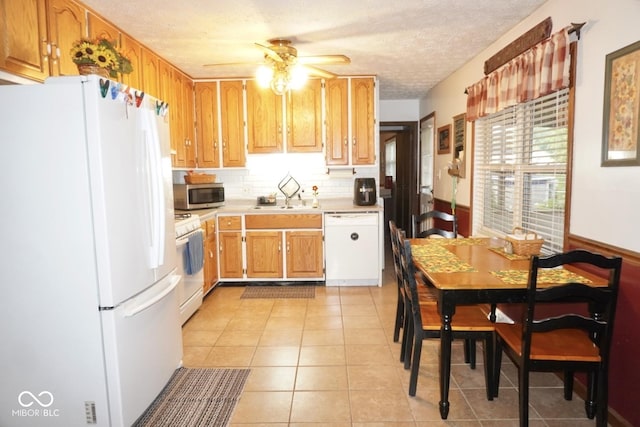 254 Bittersweet Dr, Whiteland, IN 46184 - kitchen with white appliances, ceiling fan, light countertops, a sink, and light tile patterned floors