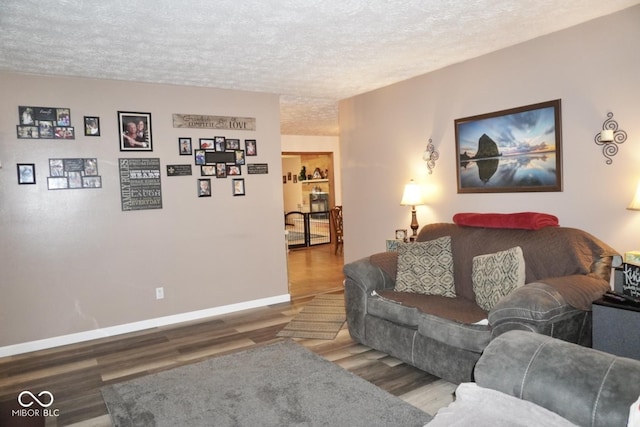 254 Bittersweet Dr, Whiteland, IN 46184 - living area featuring a textured ceiling, wood finished floors, and baseboards