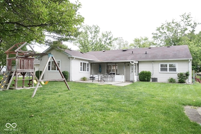 254 Bittersweet Dr, Whiteland, IN 46184 - rear view of house with a playground, a patio, a lawn, and central AC unit
