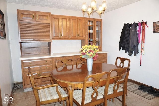 254 Bittersweet Dr, Whiteland, IN 46184 - dining space with a chandelier, light tile patterned floors, a textured ceiling, and baseboards