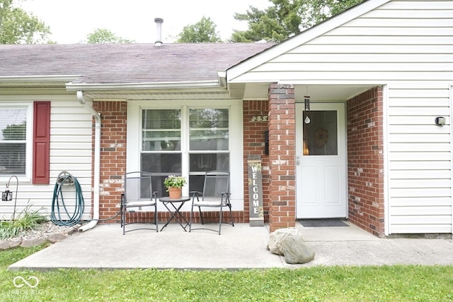 254 Bittersweet Dr, Whiteland, IN 46184 - doorway to property featuring brick siding and a shingled roof
