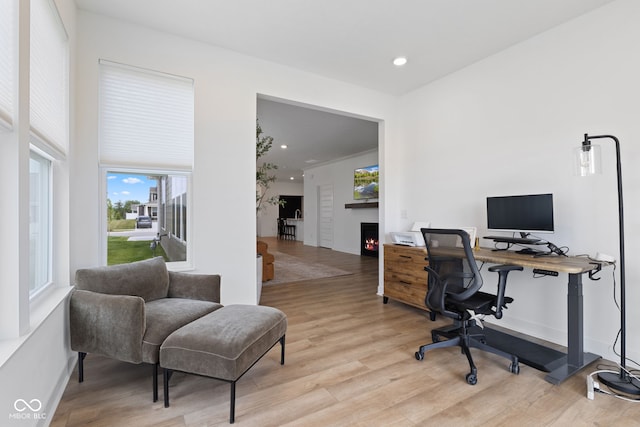 14848 Stonneger St, Westfield, IN 46074 - office space featuring light wood-style flooring, recessed lighting, and a warm lit fireplace