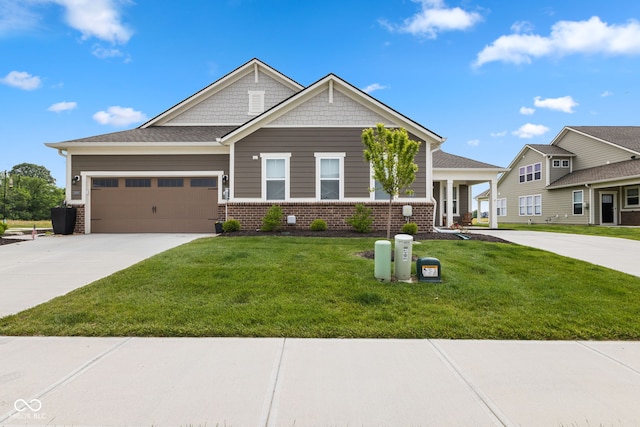 14848 Stonneger St, Westfield, IN 46074 - craftsman inspired home with driveway, a front lawn, a garage, and brick siding