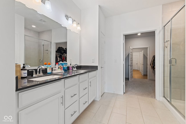 14848 Stonneger St, Westfield, IN 46074 - full bath with a walk in closet, double vanity, a shower stall, tile patterned flooring, and recessed lighting