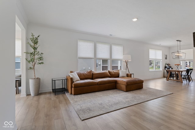 14848 Stonneger St, Westfield, IN 46074 - living room with light wood-type flooring, a chandelier, baseboards, recessed lighting, and crown molding