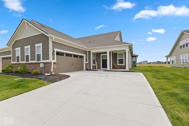 14848 Stonneger St, Westfield, IN 46074 - view of front of home featuring an attached garage, brick siding, a front yard, concrete driveway, and covered porch